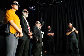 Image of people wearing 3D glasses with a black background 