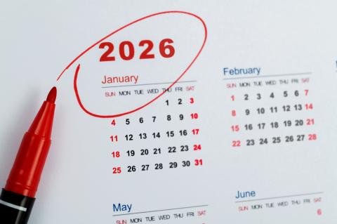 A photo of a calendar. The year 2026 is circled in red ink and the red marker pen sits beside the calendar. 