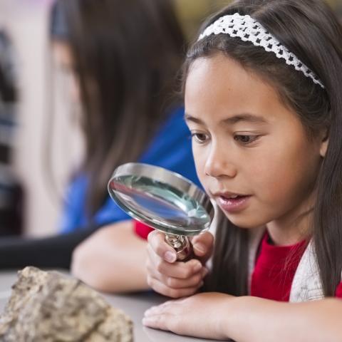 Student with magnifying glass