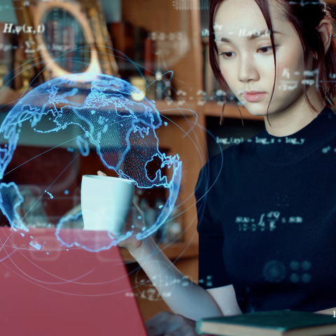 Woman working at laptop, with 3D globe graphic and math equations in the foreground