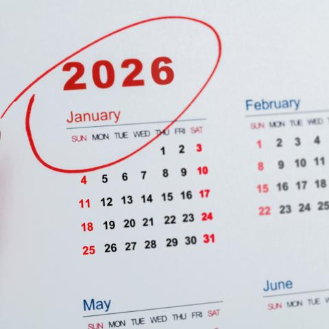 A photo of a calendar. The year 2026 is circled in red ink and the red marker pen sits beside the calendar. 