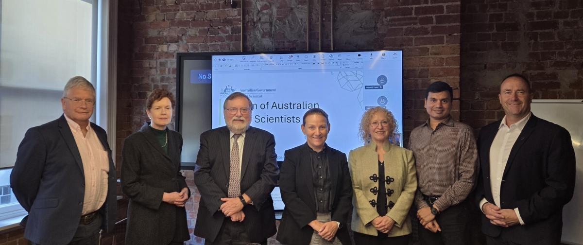 Seven people stand in front of a screen at the Forum of Australian Chief Scientists meeting. From left to right: Professor Hugh Durrant-Whyte, Dr Amanda Caples, Professor Tony Haymet, Professor Kerrie Wilson, Dr Tara Martin, Professor Sharath Sriram and Dr John Roche.