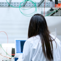 Woman in laboratory facing away from the camera