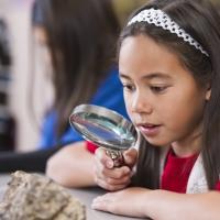 Student with magnifying glass