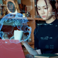 Woman working at laptop, with 3D globe graphic and math equations in the foreground