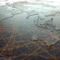 Map of the world with curved lines indicating connections overlayed