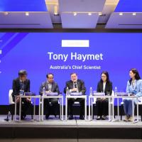 An image of a group of 5 people seated on stage. In front of a screen with the words: Tony Haymet Australia's Chief Scientist